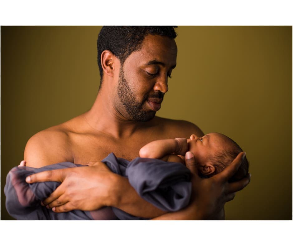 A father holding his newborn baby