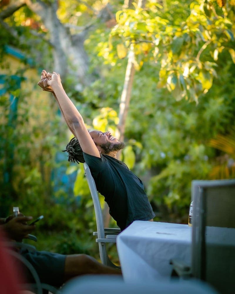 A person stretching their arms up outdoors